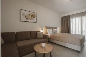 a hotel room with a couch and a bed at QUERCUS Boutique Living in Valanidorachi +33 photos