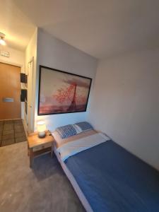 a bedroom with a large bed and a table at Järnvägsgatan 21 in Sundbyberg