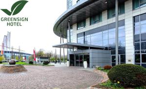 a large glass building with a walkway in front of it at Welcome Hotel Gelsenkirchen in Gelsenkirchen