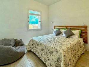 a bedroom with a large bed and a window at Panoramic Villa In The Lucca Hills in Capannori