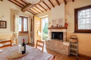 a living room with a table and a fireplace at Historic Village With Pool Near Todi in Todi