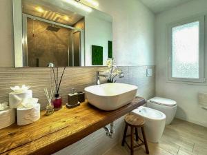 a bathroom with a sink and a toilet at Panoramic Villa In The Lucca Hills in Capannori +32 photos