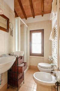 a bathroom with a toilet and a sink and a tub at Historic Village With Pool Near Todi in Todi +23 photos