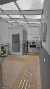 a large room with a kitchen and a hallway with at Blues Hostel in Konin +4 photos