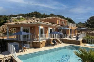 a villa with a swimming pool and a house at Seaside Villa With Panoramic Views In Les Îles D'or in La Londe-les-Maures