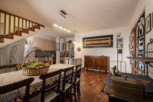 a kitchen and dining room with a table and chairs at Historic Villa With Pool In The Heart Of Chianti in Monteriggioni