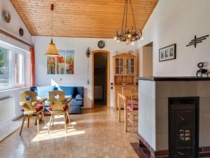 a living room with a table and chairs and a fireplace at Chalet in Maishofen near Ski Slopes in Maishofen