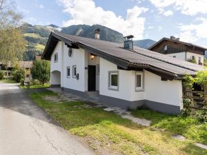 a white house with a mountain in the background at Chalet in Maishofen near Ski Slopes in Maishofen