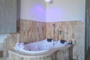 a bath tub in the corner of a bathroom at חלום לים - סוויטות מדהימות עם מרפסת לים באשקלון in Ashqelon
