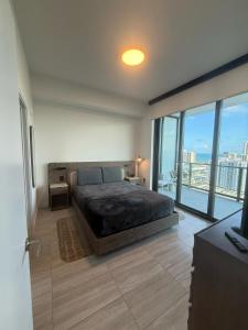 a bedroom with a large bed and a large window at New 1Bed 1 bath Ocean view in Miami Beach +30 photos
