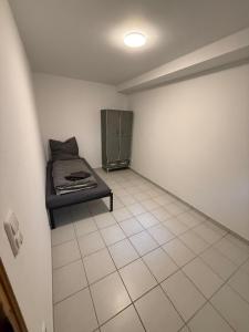 a room with a bed and a tiled floor at Cakir Home in Erftstadt