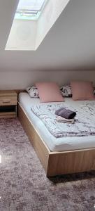a bed in a room with a window at L&G ROOMS in Ljubljana