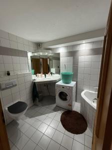 a bathroom with a sink and a washing machine at Cakir Home in Erftstadt +21 photos