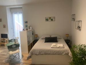 a bedroom with a bed and a desk in it at Le Studio d'en O, au coeur de la ville haute in Pornic
