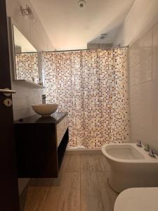 a bathroom with a sink and a shower curtain at Urbanstay in Villa Constitución