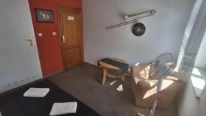 a living room with a couch and a chair at Dom Pracy Twórczej in Gryfice