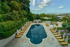 a swimming pool with lounge chairs and a resort at Conrad Istanbul Bosphorus in Istanbul +190 photos