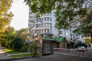 a large white building with a gate in front of it at Tokyo Luxury apartment in Odesa