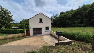 una pequeña casa blanca en medio de un campo en Gîte La Salamandre au Sud de Sarlat, en Groléjac
