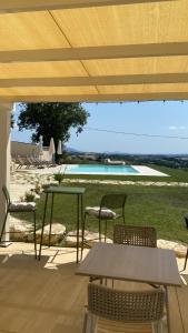 a patio with a table and chairs and a pool at Agriturismo La Quercia Bella in Collazzone