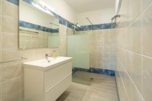 a white bathroom with a sink and a mirror at Casa Dos Amigos in Budens +16 photos