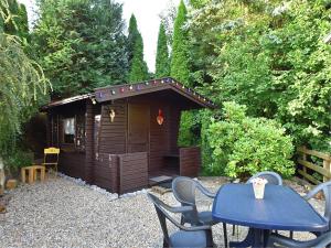 a small wooden cabin with a table and chairs at Gruppen- Ferienhaus in Wieda in Wieda