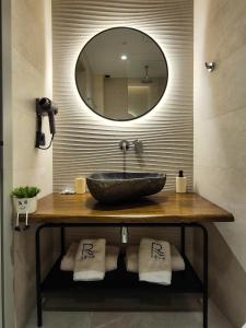 a bathroom with a sink and a mirror at Rêve Studio Apartments in Sarandë +142 photos