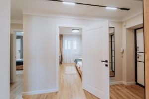 a room with a door leading to a bedroom at City Center 2BR with Sauna, Walkable spot in Chişinău +110 photos