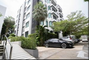 a black car parked in front of a building at Kamala Regent in Kamala Beach
