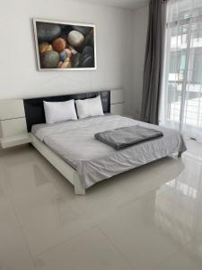 a bedroom with a bed with a painting on the wall at Kamala Regent in Kamala Beach