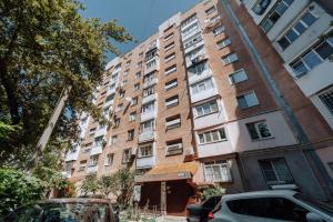 an apartment building with cars parked in front of it at Luxury 2BR Flat Sauna & Living Cathedral Nearby in Chişinău