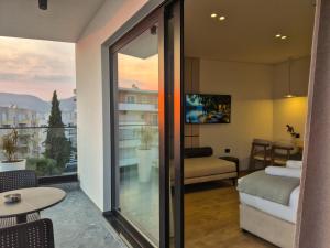 a room with a balcony with a view of a bedroom at Rêve Studio Apartments in Sarandë