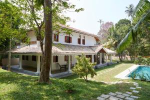 an exterior view of a house with a swimming pool at Kalukanda House in Weligama