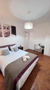 a bedroom with a large bed with two towels on it at airport room in Lisbon