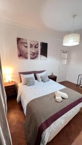 a bedroom with a bed and two pictures on the wall at airport room in Lisbon