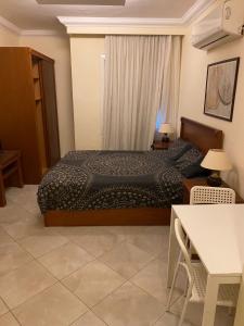 a bedroom with a bed and a table at Delta sharm in Sharm El Sheikh