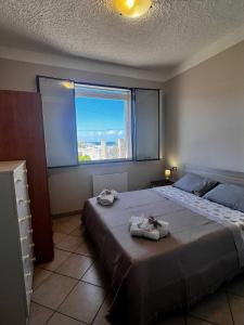 a bedroom with a large bed with towels on it at West Sicily Beach in Balestrate