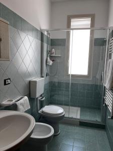 a bathroom with a toilet and a shower and a sink at West Sicily Beach in Balestrate +37 photos