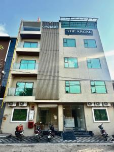 a building with motorcycles parked in front of it at Hotel The Argal By Basotel, Vijay Nagar in Indore