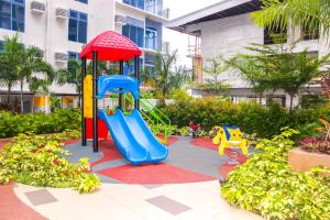 a playground with a slide in a garden at Nap Trap in Cebu City