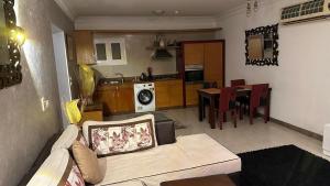 a living room with a couch and a kitchen at Delta n1 Sharm in Sharm El Sheikh