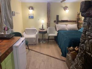 a bedroom with a bed and a table and chairs at BerryWood in Verkhnyaya Stynava
