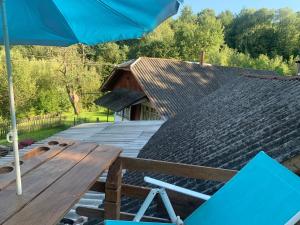 a picnic table and an umbrella on a deck at BerryWood in Verkhnyaya Stynava