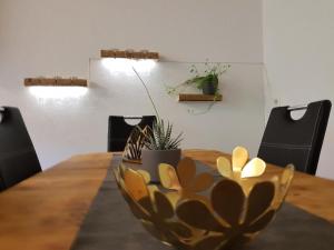 a wooden table with a bowl on top of it at Ferien Im Gugger Wohnung Stockberg in Nesslau