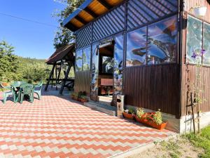 a building with a patio with a table and chairs at Casa Elena - vedere la munte in Bran