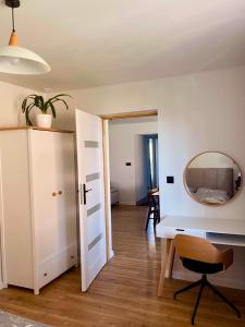 a room with a white desk and a mirror at Dom pod orzechem in Spytkowice