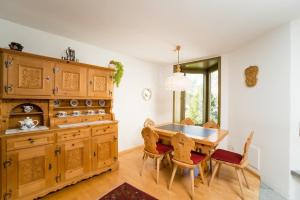 una sala da pranzo con tavolo e sedie in legno di Chesa Aquileja Trüb a Pontresina