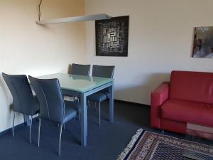 a room with a table and chairs and a couch at Gemütliche Ferienwohnung Im Disentiserhof in Disentis