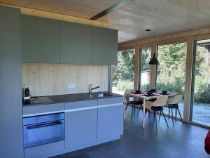 a kitchen with a sink and a table with chairs at Gartenbungalow 2 3 Personen in Arbon