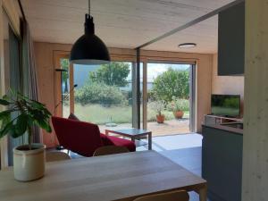 a kitchen and living room with a table and chairs at Gartenbungalow 2 3 Personen in Arbon